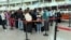 People line up at check-in desks at the airport in Zvartnots, west of Yerevan, in April.
