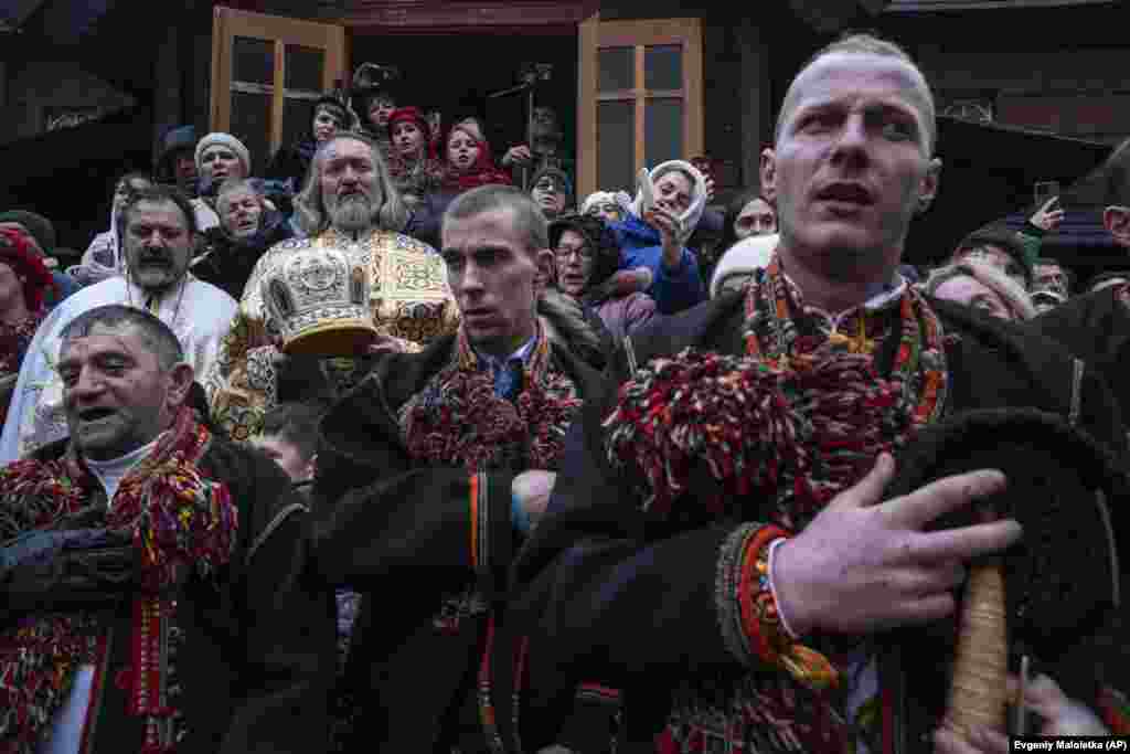 Men sing Christmas carols in front of the church. This year, many Ukrainians celebrated Christmas on December 25 for the first time rather than in January, which is when Russia marks the festival.&nbsp;The change was enacted in legislation in July. The law signed by President Volodymyr Zelenskiy noted that Ukrainians wanted to &quot;live their own life with their own traditions and holidays,&quot; adding that it allows them to &quot;abandon the Russian heritage of imposing Christmas celebrations on January 7.&quot;&nbsp; &nbsp;