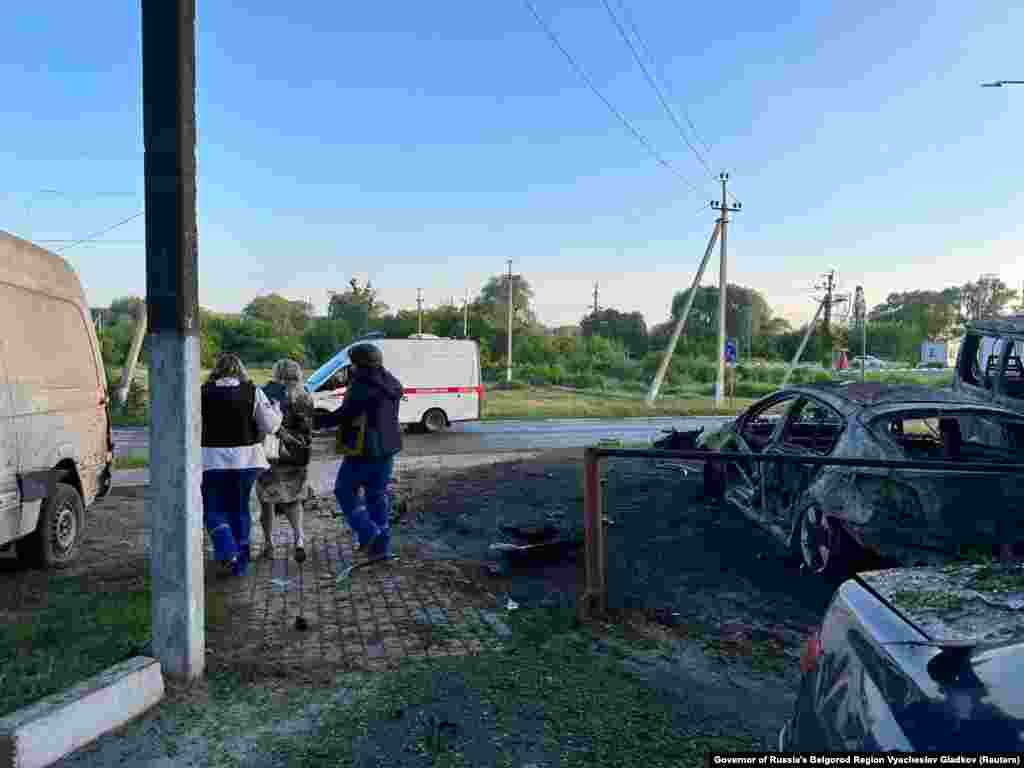 A woman is led away by two people wearing paramedic uniforms in Shebekino.&nbsp; Gladkov said on Telegram that at 3:15 a.m. on May 31 &quot;Grad shells&quot; injured four people, with one man suffering serious wounds from shrapnel. RFE/RL is not able to verify the claims.&nbsp;