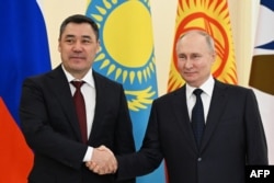 Президент России Владимир Путин (справа) пожимает руку президенту Кыргызстана Садыру Жапарову на саммите Евразийского экономического союза в Санкт-Петербурге. Россия, 25 декабря 2023 года.