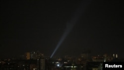 A searchlight looks for drones in the sky over Kyiv during a Russian drone strike on May 19.