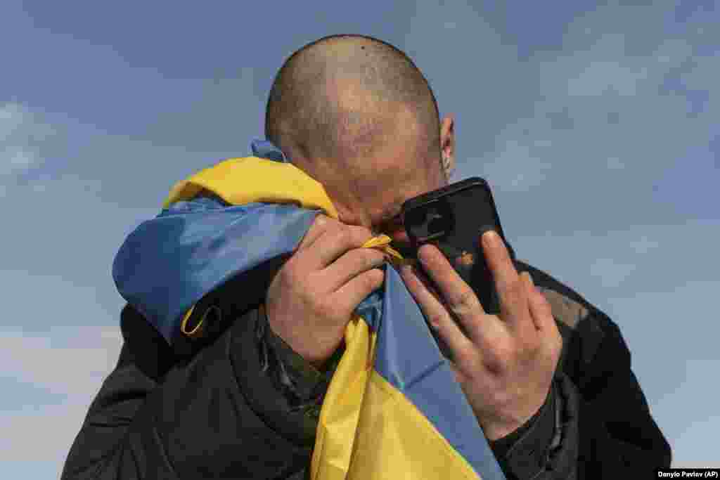 A recently swapped Ukrainian prisoner of war cries as he calls relatives after a prisoner exchange on the Ukrainian-Russian border on January 31.