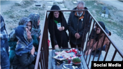 Mourners at the grave of Mehdi Babrinejad who was killed by Iranian security forces during protests last year. 