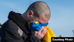 A Ukrainian POW reacts after being swapped in a prisoner exchange with Russia on January 31. 