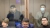 Quandyq Bishimbaev (top left) and Baqytzhan Baizhanov are seen in a courtroom in Astana on March 12.