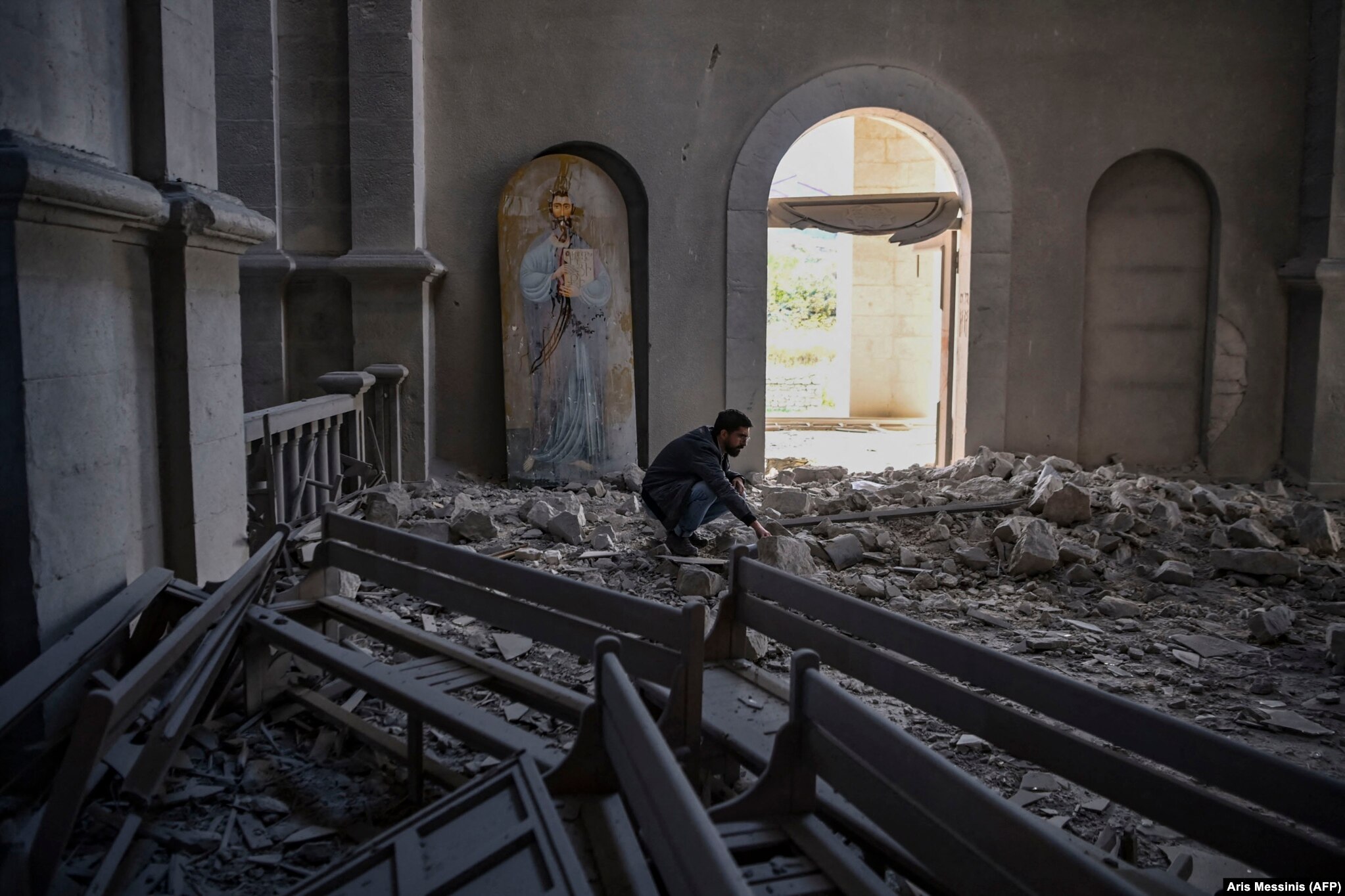 A man amid the rubble inside Susa’s Ghazanchetsots Cathedral on October 8, 2020 after it was hit twice by missiles shortly before the city was captured by Azerbaijani forces.
