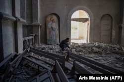 A man amid the rubble inside Susa’s Ghazanchetsots Cathedral on October 8, 2020 after it was hit twice by missiles shortly before the city was captured by Azerbaijani forces.