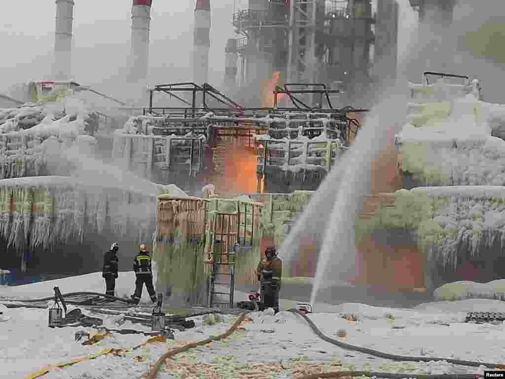 Russian firefighters attempt to extinguish a blaze at a gas terminal in the Baltic Sea port of Ust-Luga on January 24.