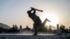 AFGHANISTAN -- Afghan youth play cricket in a field in Kabul on September 3, 2023. 