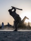 AFGHANISTAN -- Afghan youth play cricket in a field in Kabul on September 3, 2023. 