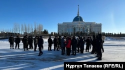 Kazakh security officers line up in Astana to block the path of protesters who wanted to head to the city's presidential office to protest the deaths of relatives killed during unrest in January 2022.