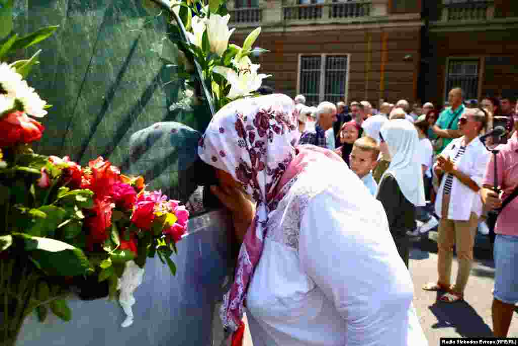 A woman embraces the hearse carrying the remains as it makes its journey. The Srebrenica killings were the only episode of the war, in which some 100,000 people died, to be legally defined as genocide by two United Nations courts.