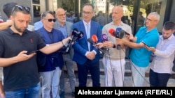 Lawyers for the defense talk to reporters outside the High Court in Podgorica on July 11.