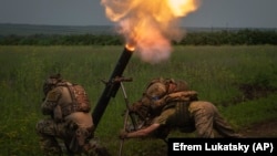 Ukrainian soldiers fire toward Russian position on the front line in Zaporizhzhya region of Ukraine on June 24.