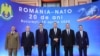 Romanian President Klaus Iohannis (third right) attends a NATO meeting with other Romanian officials.