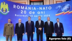 Romanian President Klaus Iohannis (third right) attends a NATO meeting with other Romanian officials.