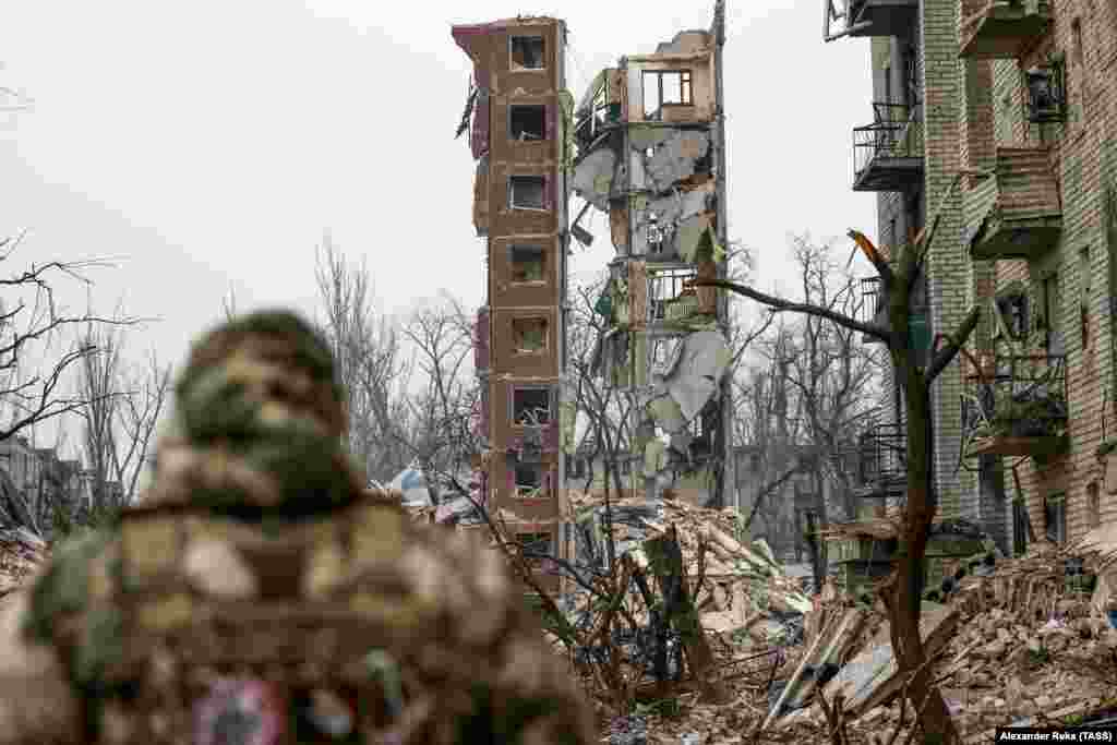 Russian fighters walk through a devastated suburb of Avdiyivka on February 22.&nbsp; Despite their effectiveness when in operation, FPV drones are unable to fly in heavy rain and can be severely hampered by fog, wind, and low light.&nbsp;