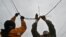 Ukrainian railroad workers repair a damaged power line after a strike in the eastern town of Druzhkivka in March.