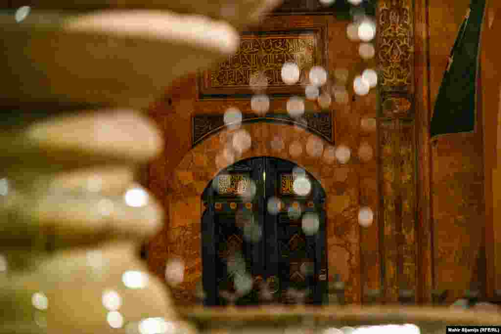 The light reflected off drops of water from a fountain in the courtyard of the Gazi Husrev-beg Mosque created bokeh balls against the Islamic writing on the walls.