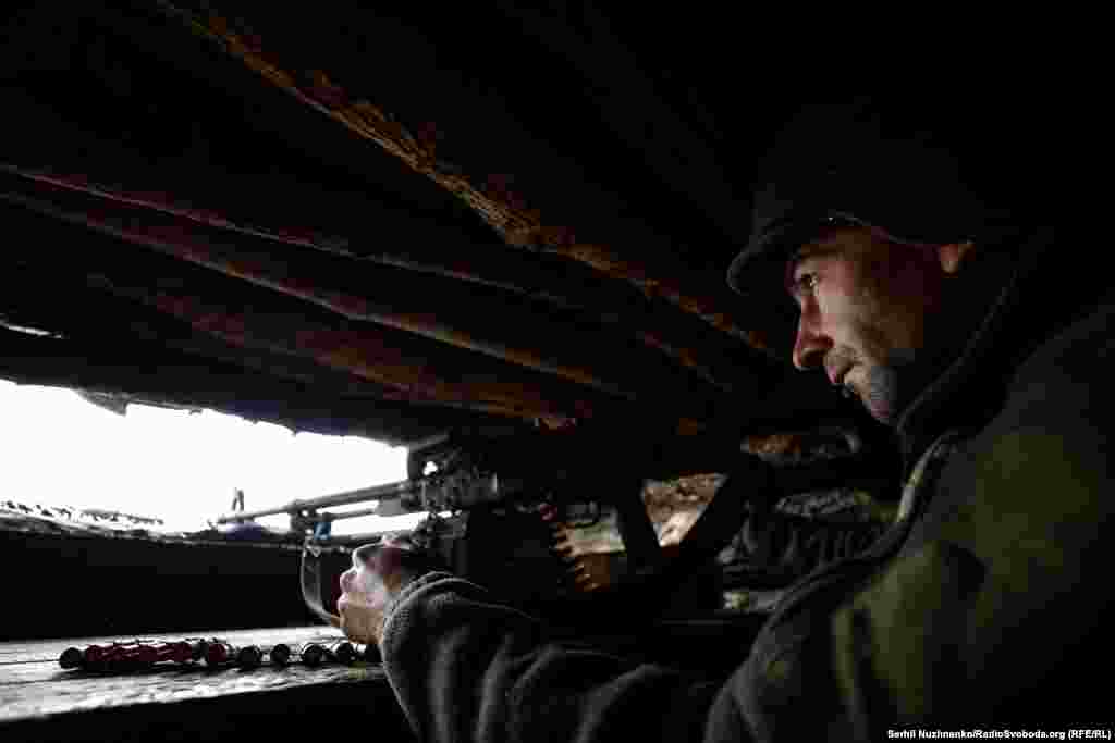 A Ukrainian soldier of the 10th Separate Mountain Assault Brigade eyes the perimeter at an undisclosed location in the Donetsk region of Ukraine on October 26. As the unprovoked Russian invasion of Ukraine enters its 21st month, neither side has significantly changed the front lines, resulting in both sides entrenching their positions in what is being called a form of static warfare. &nbsp;