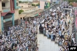 Residents take part in a July 19 peace rally to protest after the recent suicide attack by militants on an army enclave in Bannu.