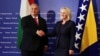 Hungarian Prime Minister Viktor Orban (left) shakes hands with Borjana Kristo, Chairwoman of Bosnia's Council of Ministers, in Sarajevo on June 22.