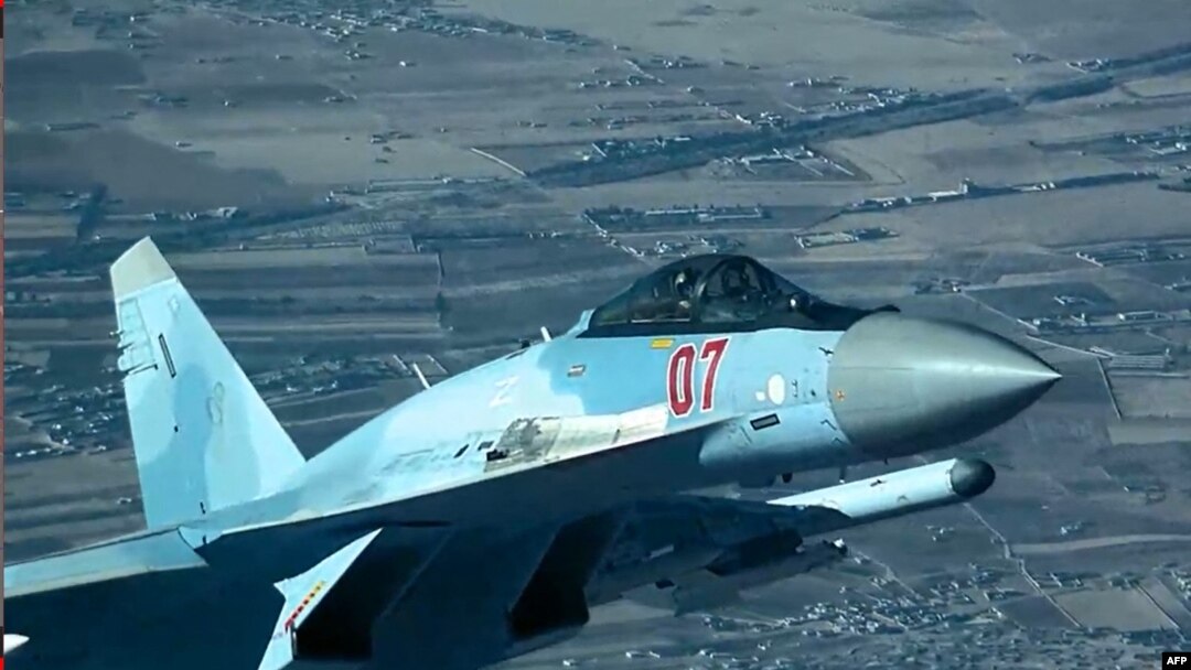 This image released by the U.S. Department of Defense shows a Russian fighter plane flying close to a US MQ-9 Reaper drone before deploying flares from a position directly over the drone on July 23, reportedly damaging its propeller.