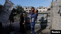 Palestinska porodica vraća se svojoj kući, uništenoj u nedavnim izraelskim vazdušnim napadima, nakon dogovorenog primirja, Deir Al-Balahu, Pojas Gaze, 14. maj 2023.