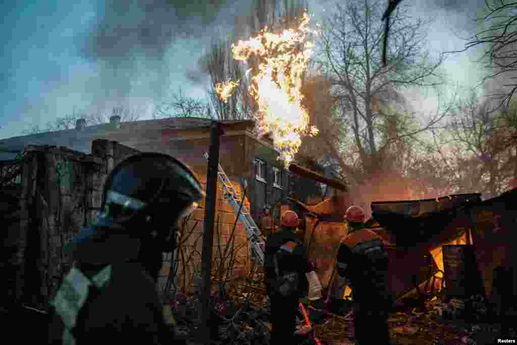 Rescuers work to put out a fire outside a damaged residential building hit by shelling in the Russian-occupied city of Donetsk on November 7. Denis Pushilin, the Russian-installed head of the occupied region, said on his Telegram account that six people were killed. This has not been independently verified.