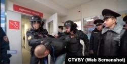 Belarusian police manhandle a detainee in Minsk.