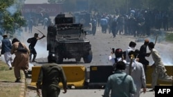 Supporters of former Pakistani Prime Minister Imran Khan clash with police during a protest in Islamabad on May 10, 2023. 