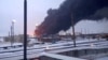 Клубы дыма от пожара, возникшего после того, как украинский беспилотник нанес удар по нефтеперерабатывающему заводу в Рязани. Россия, 13 марта 2024 года