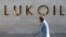 A woman walks past the headquarters of Russia's oil producer LUKoil in Moscow. (file photo)