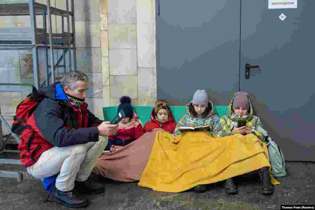 People take shelter in a subway station during an air raid in Kyiv.