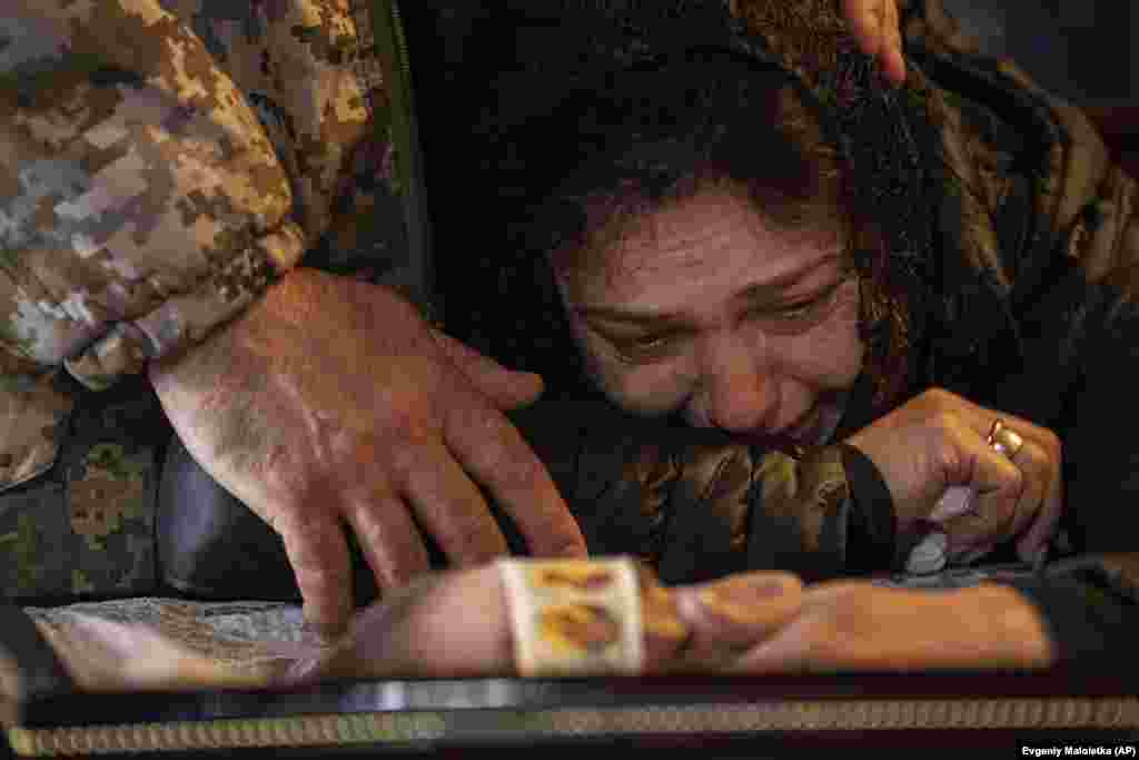 Lilia cries next to the coffin of her son, Anton Zayets, a senior lieutenant in the Ukrainian armed forces, during a funeral ceremony at St. Michael&#39;s Golden-Domed Monastery in Kyiv on March 27.