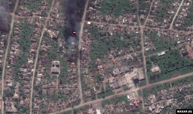 Същият квартал в града, показан в сателитна снимка от 15 май 2023 г.