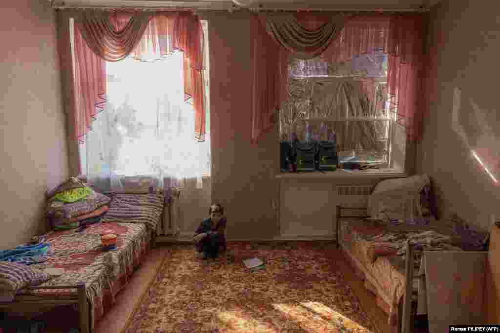 Borys, 11, sits alone in the small room that he shares with his family at a refugee reception center in the southern city of Mykolayiv. Kyiv says that over 500 children have been killed since Russia launched its unprovoked invasion in February 2022, a grim milestone in the more than 20-month-long conflict.
