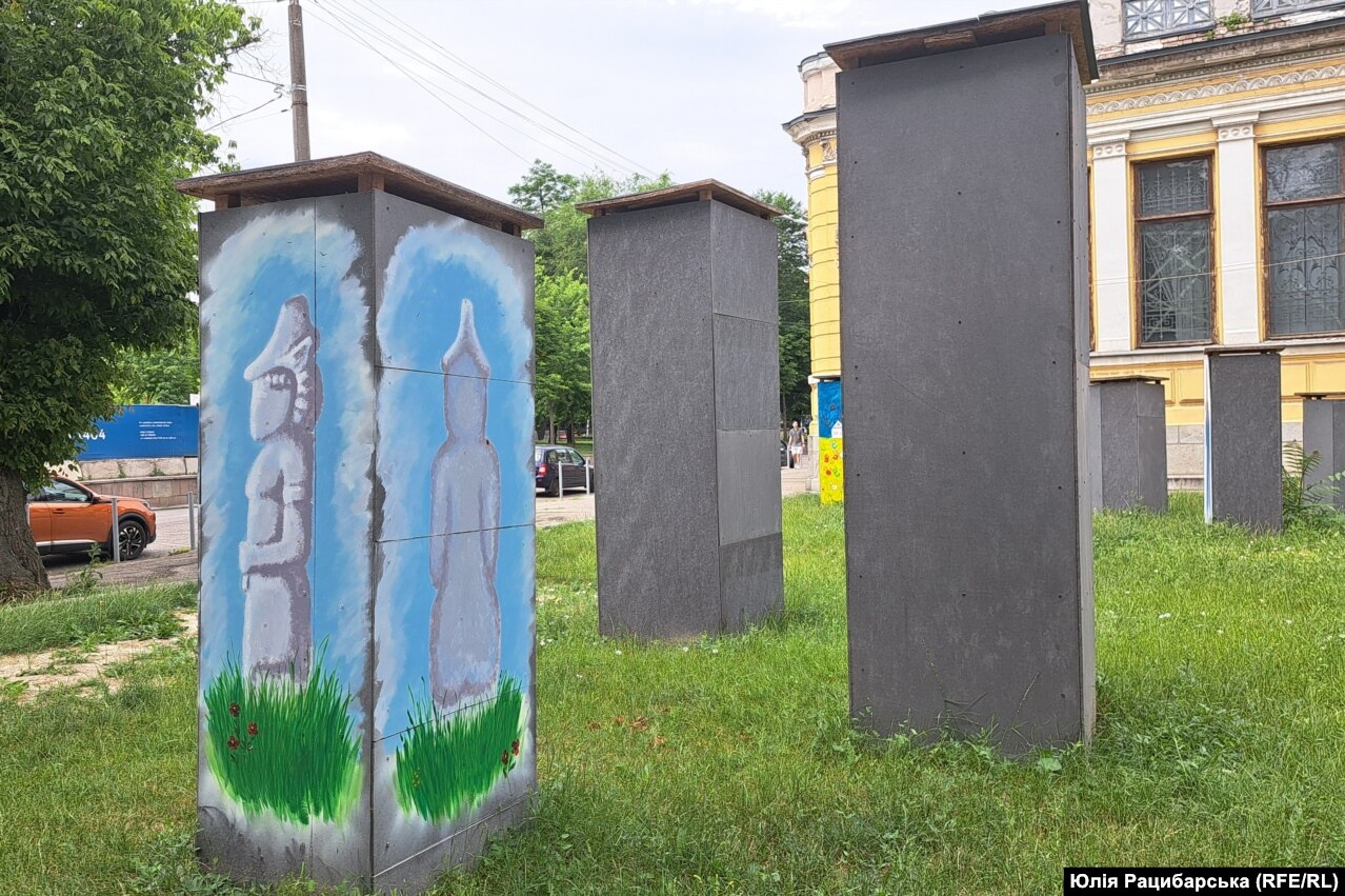 Stone sculptures from the collection of the historical museum in Dnipro stand enclosed in protective boxes.