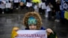 A child holds a sign saying "demobilization" in Ukrainian during a protest by soldiers' families in November 2023.