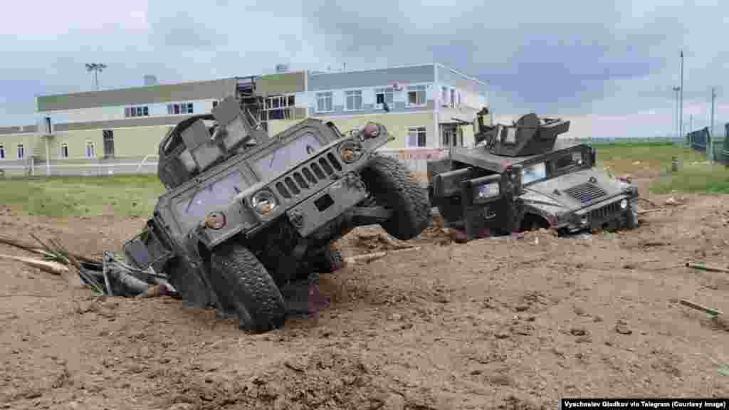 This image, showing U.S.-made Humvees in an apparent explosion crater, is from a video released by Russian authorities on May 23 after what is described as a cross-border raid into Russia&#39;s Belgorod region that began a day earlier.