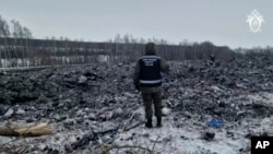 A rescue worker surveys the site of a Russian military plane crash in the Belgorod region on January 24.