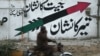 A motorcyclist rides past a wall painted with the Pakistan People&#39;s Party Parliamentarians (PPPP) logo of an arrow along a street in Karachi on January 12.<br />
<br />
Electoral symbols continue to play an important role in ensuring voters have a voice in the democratic process.