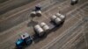 A tractor collects straw on a field at a farm in Zhurivka, Kyiv region, Ukraine, on August 10.