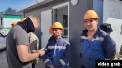 Migrant workers in Khabarovsk, Russia, get checked during a raid to find illegal immigrants.