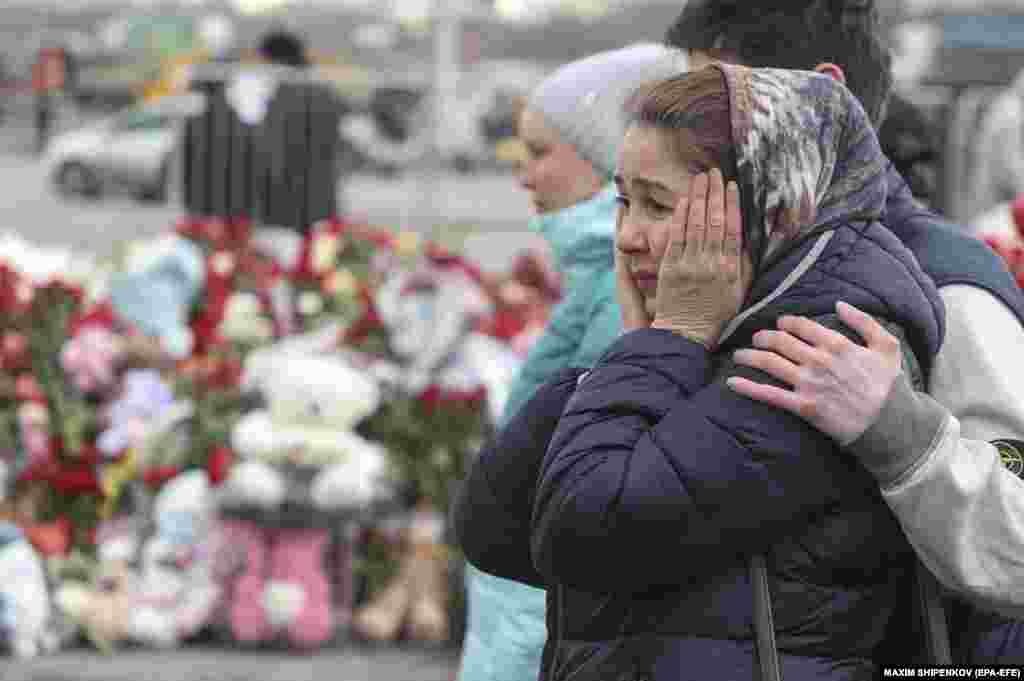 People comfort each other at the Crocus City Hall concert venue in Krasnogorsk, where a terrorist attack on March 22 claimed the lives of 137 people, including three children, just days after President Vladimir Putin was elected to his fifth term of office.
