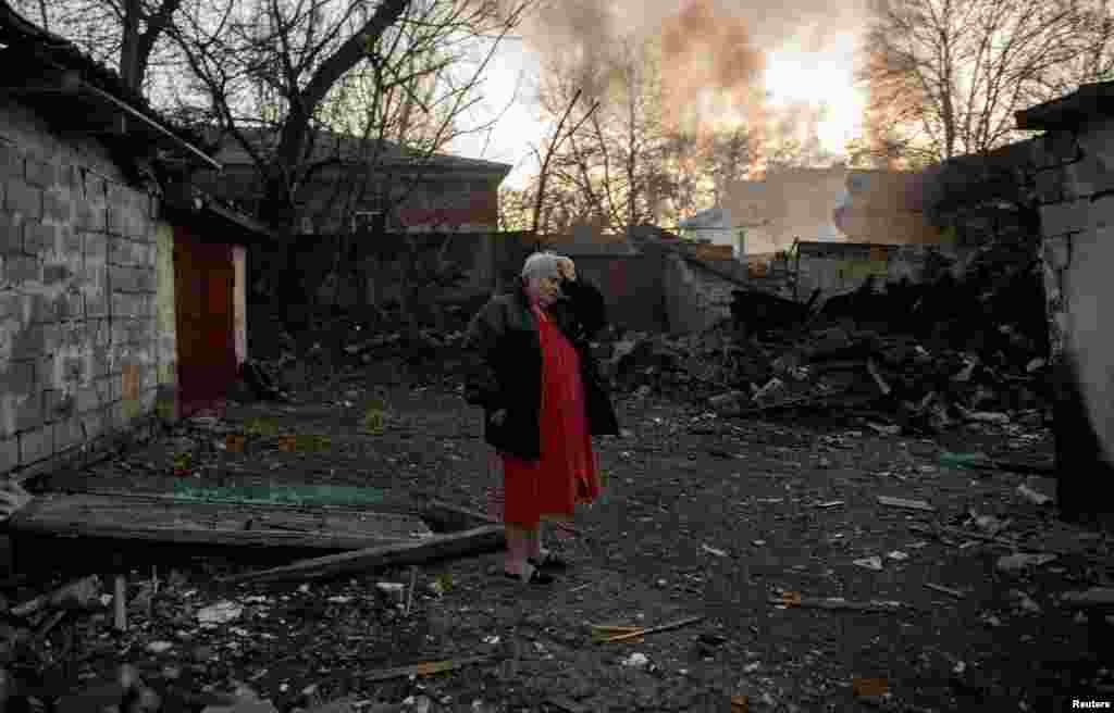 A woman reacts to the destruction in the courtyard. &nbsp;