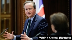 Foreign Secretary David Cameron speaks to reporters in Pristina on January 4. 