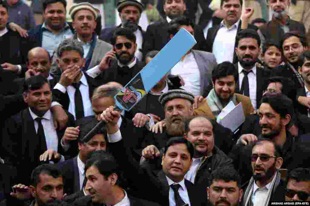 Some of the symbols have caused controversy, such as these supporters of jailed former Prime Minister Imran Khan&#39;s party Pakistan Tehrik-e Insaf (PTI) holding the party&#39;s electoral symbol of a cricket bat after a hearing outside the Peshawar High Court in Peshawar on January 10 &nbsp;