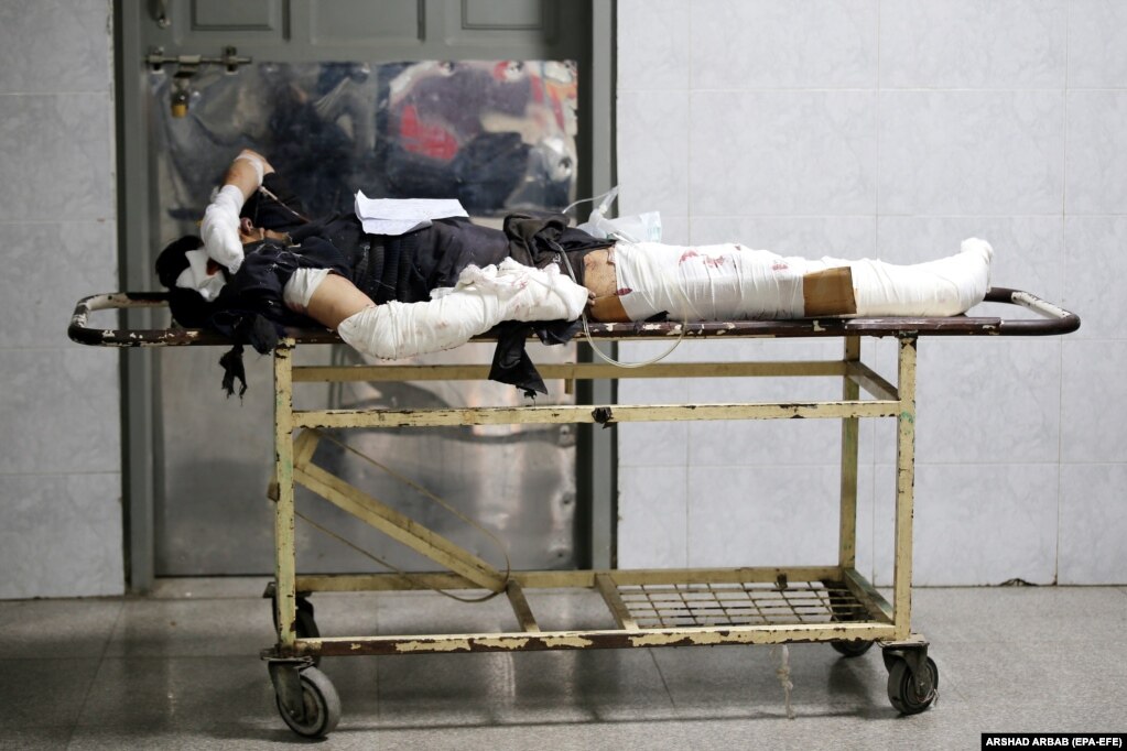 ...as an injured man lies on a stretcher at the hospital. &nbsp;
