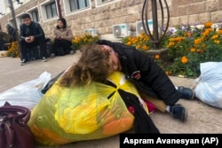 A child sleeps on a pile of belongings as ethnic Armenians prepare to flee Stepanakert in September 2023. Stepanakert is known as Xankendi in Azerbaijani and is the largest city of the Nagorno-Karabakh region.